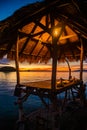 Sunset over wooden beach bar in sea and hut on pier in koh Mak island, Trat, Thailand Royalty Free Stock Photo