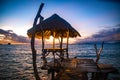 Sunset over wooden beach bar in sea and hut on pier in koh Mak island, Trat, Thailand Royalty Free Stock Photo