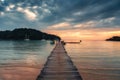 Sunset over wooden pier and boat in tropical sea at Koh Kood Island Royalty Free Stock Photo