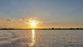 Sunset over the Zambezi River. The sun colors the sky and clouds in golden hues. Royalty Free Stock Photo