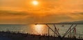 Sunset overlooking sea bay and beach with unidentified tourists, Black sea coast, Gelendzhik, Russia