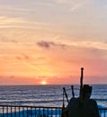 Sunset Pacific Ocean fence half Moon Bay California bagpipe player