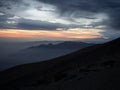 Sunset panorama of mountain range silhouette layers haze dust fog clouds at Misti volcano Arequipa Peru Andes