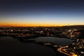 Sunset panorama over northern Lombardy lakes showing light pollution and Alps sihouette Royalty Free Stock Photo