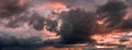 Sunset panorama with raspberry clouds over a small town Royalty Free Stock Photo