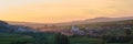 Sunset panorama of Transylvanian village surrounded by hills, at Petrestii de Jos, Romania - view from Turda gorge