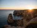 Sunset panorama view of rock cliff coast navy beach Praia da Marinha Caramujeira Lagoa Algarve atlantic ocean Portugal