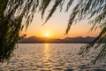 Sunset panoramic view of the West Lake in Hangzhou, China. Beautiful silhouettes in sunset colors Royalty Free Stock Photo