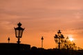 Sunset in Paris with silhouette of the luminaries.