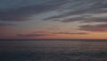 Sunset on pebble beach with sea waves of mediterranean sea