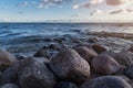 Sunset photo of the stones on the shoreline of the finnish bay in St. Petersburg. Rocks located on the beach. against the Royalty Free Stock Photo