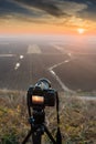 Sunset photography. Camera with tripod Sunset