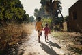 Sunset Picture of African Boys Brothers Walking Outdoors in a Typical Landscape