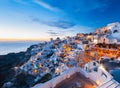 Sunset and the picturesque Oia village, Santorini, Greece.
