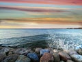 Seafront sunset colorful sky cloudy pink green water skyline, light reflection on seawater, gold summer Royalty Free Stock Photo