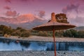 Sunset with sunbed and parasol on the beach and Mountain Tahtali in the background. Tourism and recreation in the