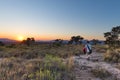 Sunset on the plateau at Blyde River Canyon, famous travel destination in South Africa. One person walking in the bush, rear view. Royalty Free Stock Photo