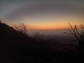 Sunset point of Mount abu, having natural scene of sunset. With dual colour sky, trees and mountain.