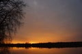 Sunset, pond and birch silhouette