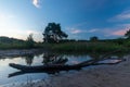 A sunset at a pond with reflections of a branch at the National park Brunssumerheide  in the Netherlands, Royalty Free Stock Photo