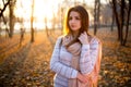 Sunset portrait of beautiful brunette young woman in autumn park Royalty Free Stock Photo