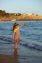 Sunset portrait of a happy dancing caucasian girl  in summer dress at the seashore Royalty Free Stock Photo