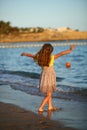 Sunset portrait of a happy dancing caucasian girl  in summer dress at the seashore Royalty Free Stock Photo