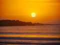 Sunset on a private beach in the town of Pringle Bay with a swarm of birds passing the setting sun