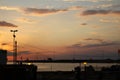 Sunset on the waterfront with the lampposts of the harbor in backlight Royalty Free Stock Photo