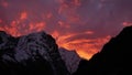 Sunset with purple and orange colored clouds in the Himalayas with snow-capped craggy mountains near sherpa village Thame, Nepal. Royalty Free Stock Photo