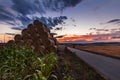 Sunset and the pyramid of straw bales Royalty Free Stock Photo