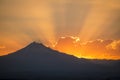 Sunset rays behind silhouette of mountain Royalty Free Stock Photo
