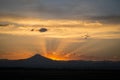 Sunset rays behind silhouette of mountain Royalty Free Stock Photo