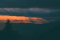 Stunning alpine landscape with golden skies and dramatic clouds