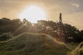 Sunset rays shine over a tall pouwhenua Royalty Free Stock Photo