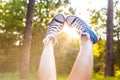 Sunset rays throug the legs in sneakers Royalty Free Stock Photo