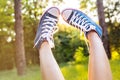 Sunset rays throug the legs in sneakers Royalty Free Stock Photo