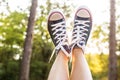 Sunset rays throug the legs in sneakers Royalty Free Stock Photo