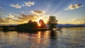 Sunset rays through trees on the lake Royalty Free Stock Photo