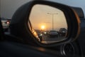 Sunset in a rear view mirror with traffic jams on expressways. sunset car driving scene