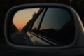 Sunset in the rearview mirror of the car Royalty Free Stock Photo