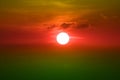 sunset on red orange green sky back soft evening cloud over space Royalty Free Stock Photo