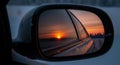 Sunset Reflected in Car Side Mirror on Winter Road Royalty Free Stock Photo