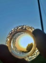 Sunset reflected in a glass orb held by hands Royalty Free Stock Photo