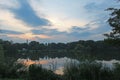 Sunset reflected in the lake framed by greenery Royalty Free Stock Photo