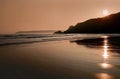 Sunset reflected in the ripples and wet sands of Threecliff Bay, The Gower, South Wales