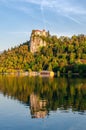 Sunset reflection of a castle in Slovenia - lake Bled in the water. Royalty Free Stock Photo