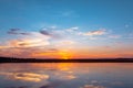 Sunset reflection lagoon. beautiful sunset behind the clouds and blue sky above the over lagoon landscape background. dramatic sky Royalty Free Stock Photo