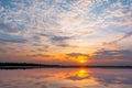 Sunset reflection lagoon. beautiful sunset behind the clouds and blue sky above the over lagoon landscape background. dramatic sky Royalty Free Stock Photo