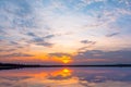 Sunset reflection lagoon. beautiful sunset behind the clouds and blue sky above the over lagoon landscape background. dramatic sky Royalty Free Stock Photo